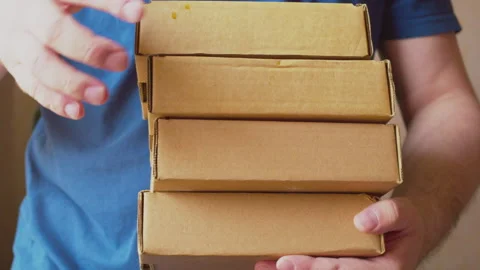Unrecognizable man with a stack of cardboard boxes in his hands 스톡 동영상 276553495