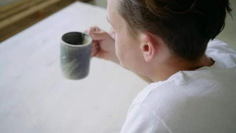 Unrecognizable man steeps herbal tea in big mug Stock Footage 79829795