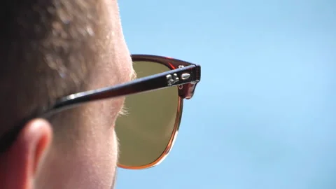 Unrecognizable man in sunglasses looking to something. Close up head of guy Stock Footage 123217556