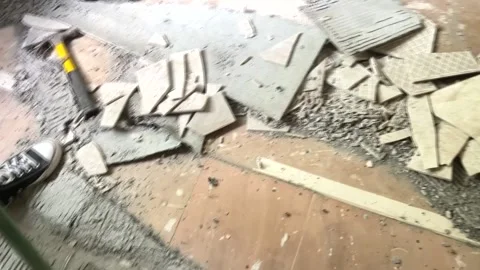 An unrecognizable man sweeps the floor after removing the old tiles. Stock Footage 206167611
