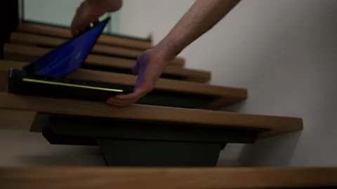 Unrecognizable man take closing his laptop and takes it from the home stairs Video stock 234660977
