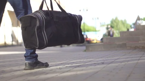 Unrecognizable man a terrorist leaves a bomb bag on the street Stock-Footage 90750122