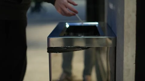Unrecognizable man throwing garbage into a bin on the street, close-up Video stock 241041908