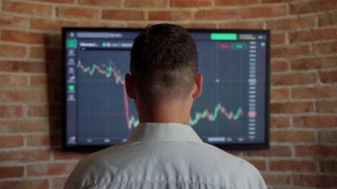 Unrecognizable man trader looking at graph currency bank money indoors Stock Footage 157455813