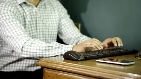 Unrecognizable Man typing at his desk, office job Stock Footage 275348473