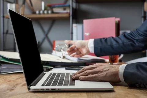 Unrecognizable man using a modern portable computer on an wooden table Stock Photos