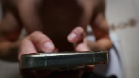 Unrecognizable Man Using Smartphone Apps While Sitting on the Toilet Stock Footage 339209918