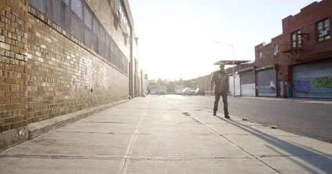 An unrecognizable man walks down a sunny Brooklyn block in 4k Stock Footage 70292529