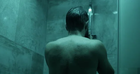 Unrecognizable man wiping face under bathroom shower Stock Footage 271159462