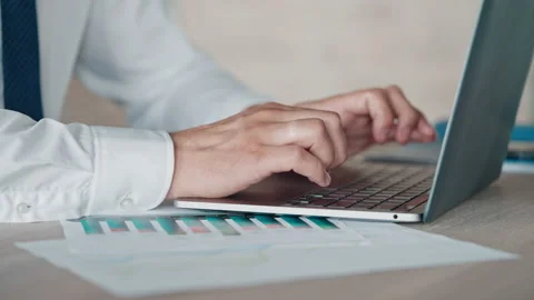 Unrecognizable man working with computer and diagrams Stock Footage 164892751