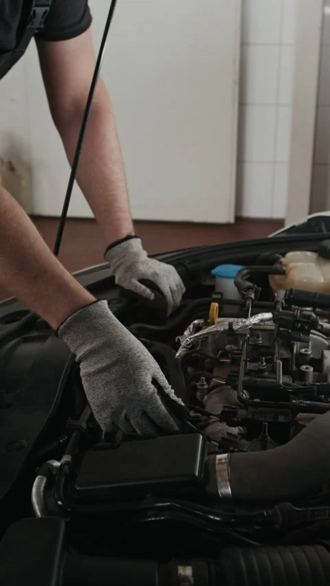 Unrecognizable Mechanic Instructing Apprentice while Checking Car Engine Stock Footage 329479409