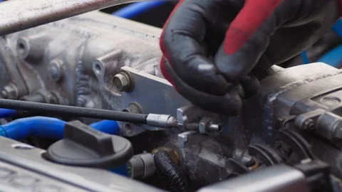 Unrecognizable Mechanic working in engine compartment in red dielectric gloves Stock Footage 128493059