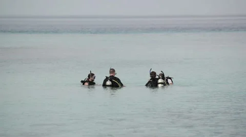 Unrecognizable men learning to dive at the resoort dive center Stock Footage 47189673