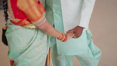 Unrecognizable mid torso Indian couple in standing embrace holding hands, love Stock Footage 341402384