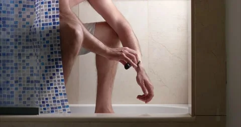 Unrecognizable middle-aged man shaving his arm in the bathroom Stock Footage 153084890