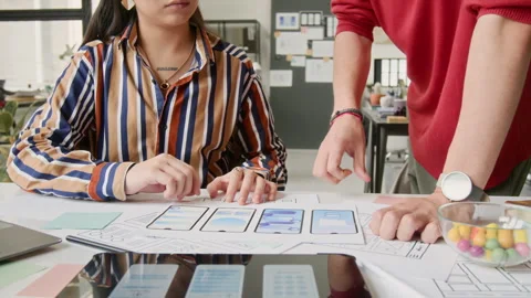 Unrecognizable Mobile App Designers Discussing Wireframe Mockup Ideas Stock Footage 327903921