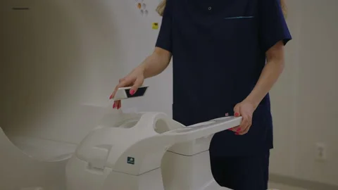 An unrecognizable nurse sets up a CT scanner before working at the clinic Stock Footage 230243166