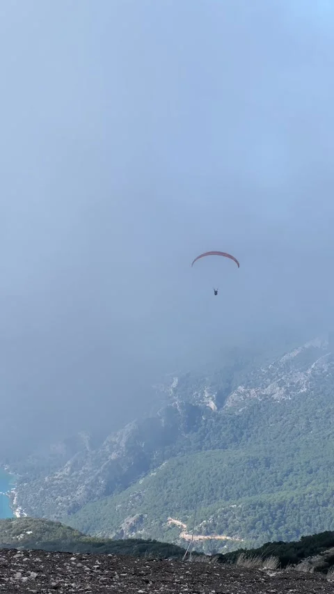 The unrecognizable paraglider flies over the mountains on a paraplane Stock Footage 265157727
