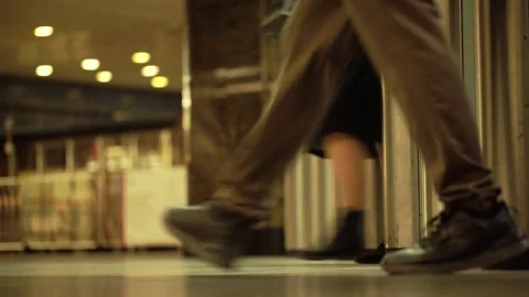 Unrecognizable passengers pass through a steel turnstile on the subway platform Stock Footage 275519573
