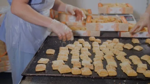 Unrecognizable Pastry Chef packing biscuits, cookies in industrial food factory Stock Footage 69984189