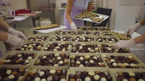 Unrecognizable Pastry Chef Packing Biscuits, Cookies In Industrial Food Factory Stock Footage 143717950