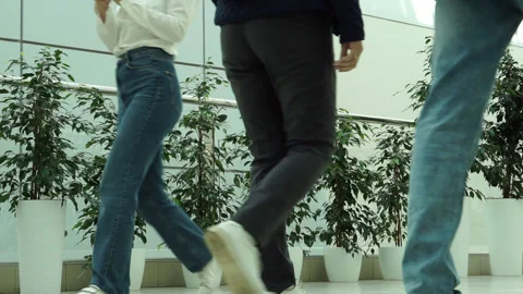 Unrecognizable people in a bright corridor. Stock Footage 252986579