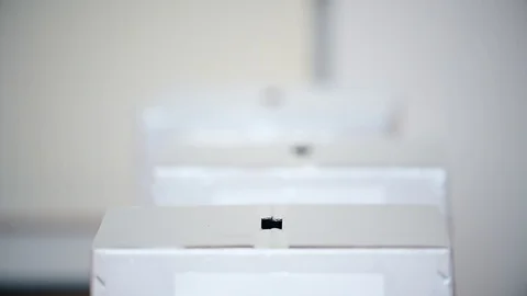 Unrecognizable people casting their votes inside voting booths during elections Video stock 119657331