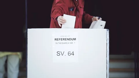 Unrecognizable people casting their votes inside voting booths during elections Video stock 119657384