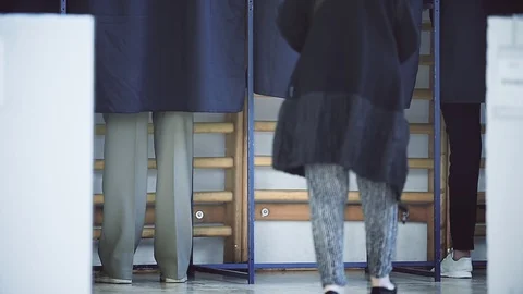 Unrecognizable people casting their votes inside voting booths during elections Video stock 119657468