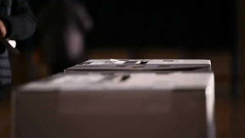 Unrecognizable people casting votes into the ballot box during elections 스톡 동영상 70520559