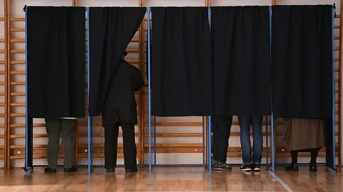 Unrecognizable people casting votes into the ballot box during elections Stock Footage 70520562