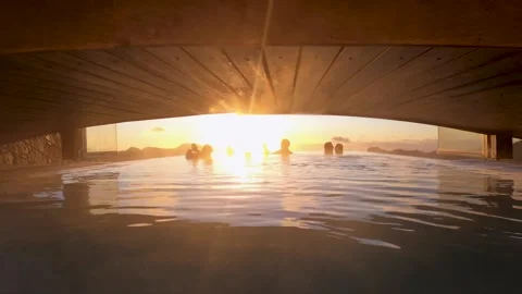 Unrecognizable people enjoying an infinity pool during sunset Stock Footage 313267760