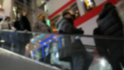 Unrecognizable people on fast-moving escalators in a modern shopping mall. Stock Footage 329779887