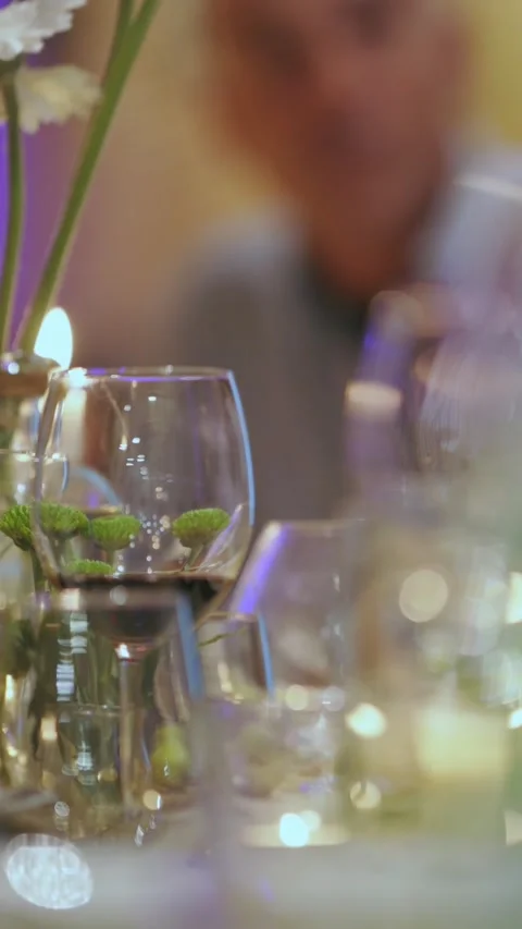 Unrecognizable people in restaurant eats and drinks wine- dining table set with Stock Footage 330555331