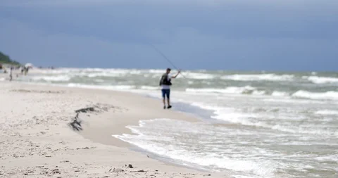 Unrecognizable people resting on the beach of Baltic Sea. Stock Footage 92597309