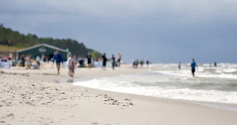 Unrecognizable people resting on the beach of Baltic Sea. Vídeos de archivo 92597372