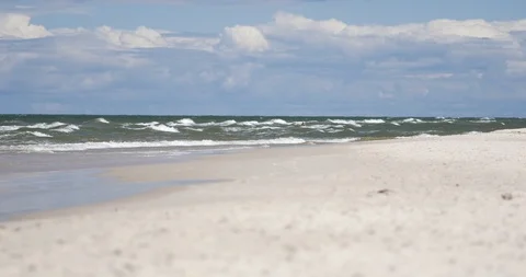 Unrecognizable people resting on the beach of Baltic Sea. Video stock 92597447