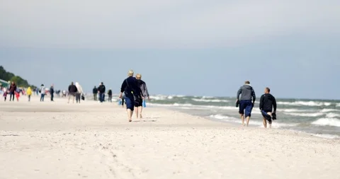 Unrecognizable people resting on the beach of Baltic Sea. Video stock 92597454