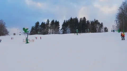 Unrecognizable people on ski T-bar lift and schuss, resort Stock Footage 121410656