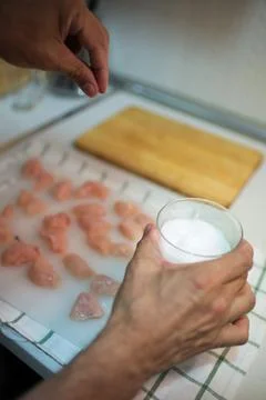 Unrecognizable person adding salt to diced chicken Stock Photos