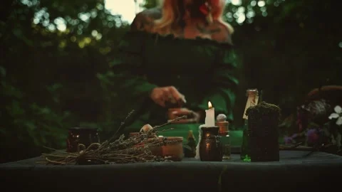 Unrecognizable person gothic blurred silhouette woman preparing healing potion Stock Footage 338125271