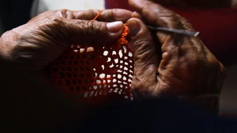 An unrecognizable person knitting with wool Stock Footage 303648237