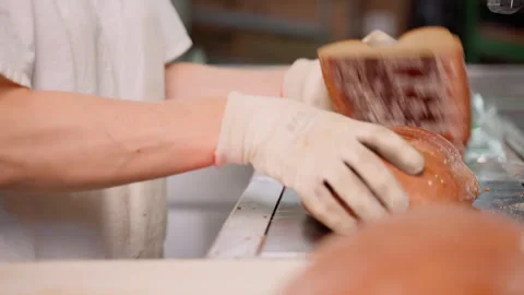 Unrecognizable person packing cut bread after long loaf machine. Slow motion Stock Footage 250276832