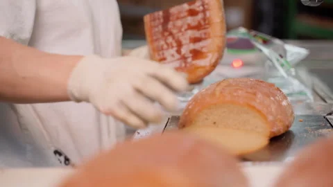 Unrecognizable person packing cut bread at factory indoors. Slow motion Stock Footage 250276853