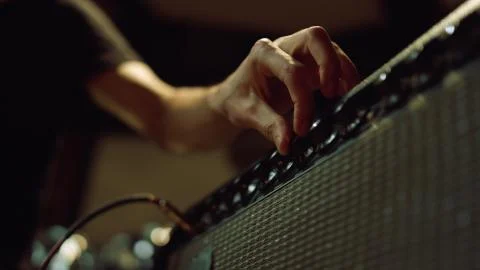 Unrecognizable person preparing equipment in studio. Man hand turning knobs. Stock Photos