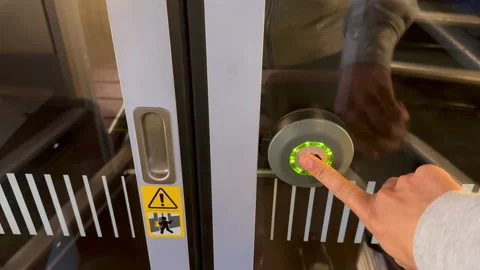 Unrecognizable person pressing the button to open an automatic door Stock Footage 255801612