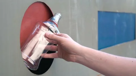 Unrecognizable person throws plastic trash into special container Stock Footage 136286661