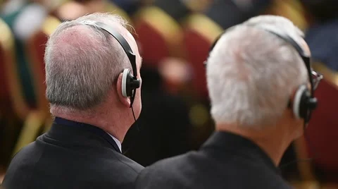 Unrecognizable person using in ear headphones for translation during event 스톡 동영상 68881514