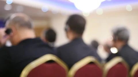 Unrecognizable person using in ear headphones for translation during event Stockbeeldmateriaal 68881654