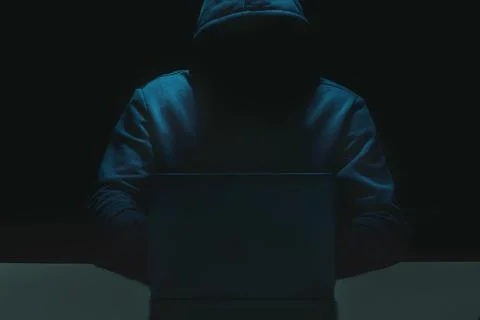 Unrecognizable person using a laptop computer with a hoodie 스톡 사진